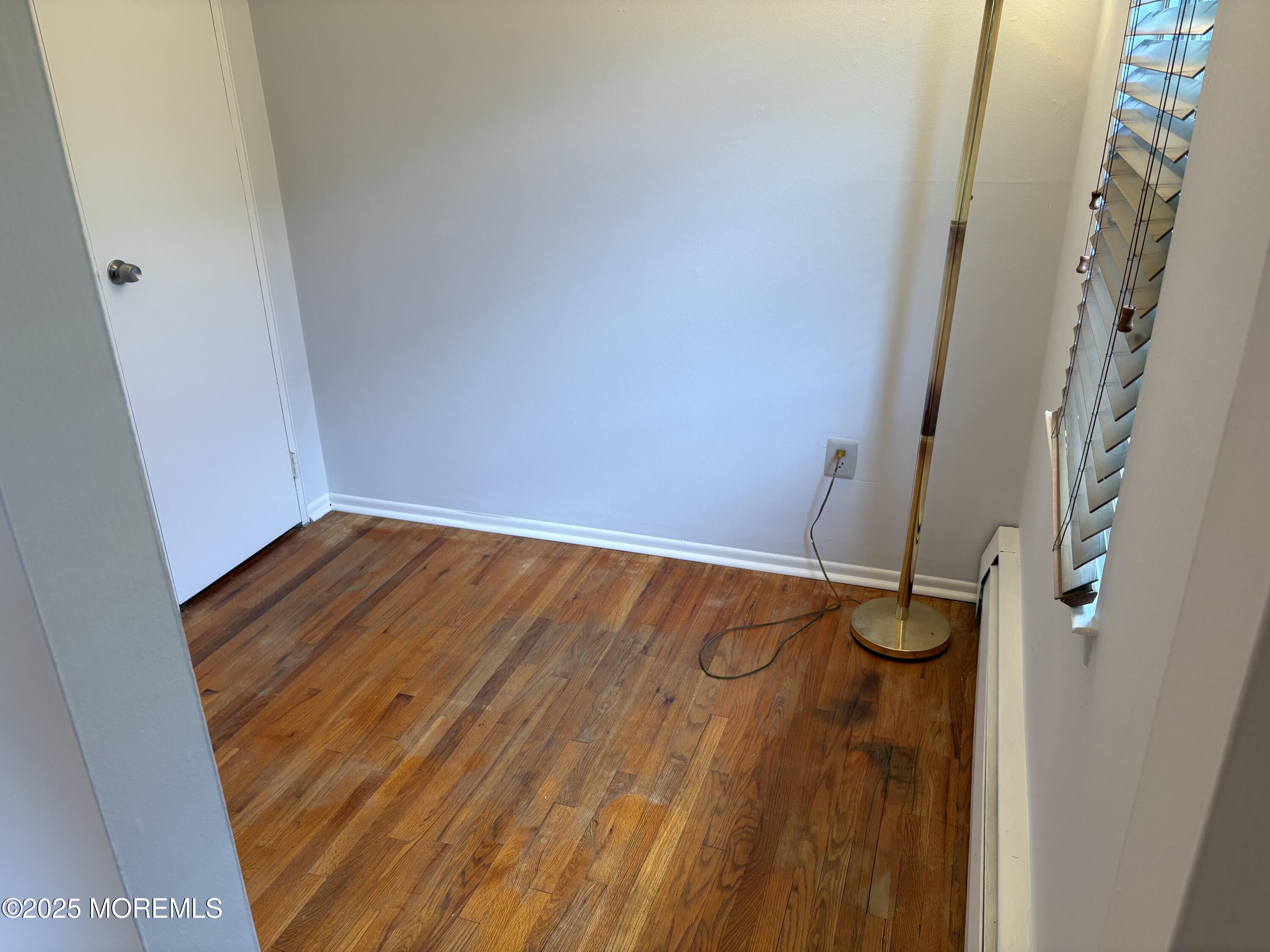 94 Stonehurst Boulevard, Unit E Freehold, NJ 07728 - Photo 7 of 11 a view of a room with wooden floor
