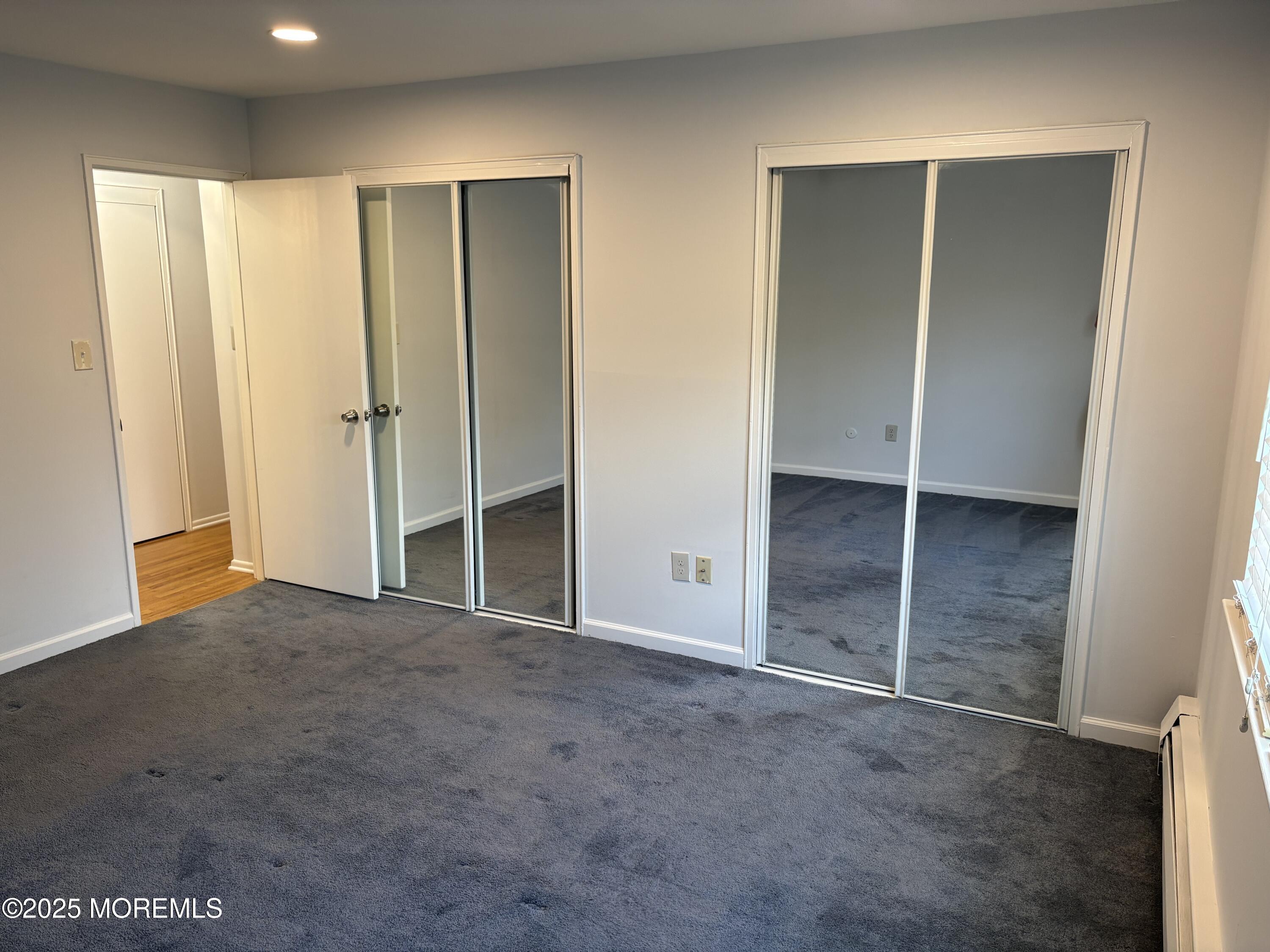 94 Stonehurst Boulevard, Unit E Freehold, NJ 07728 - Photo 10 of 11 an empty room with closet