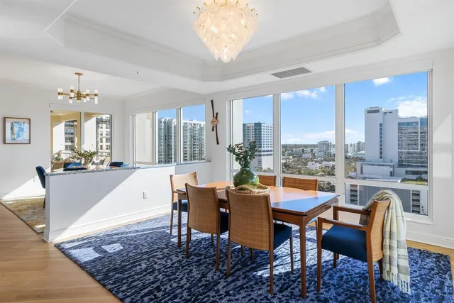 a kitchen with stainless steel appliances granite countertop a kitchen island a stove a table and chairs