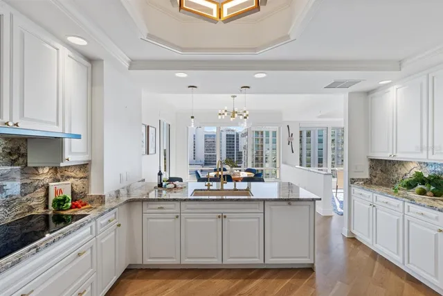 a bathroom with a granite countertop sink toilet a mirror and shower