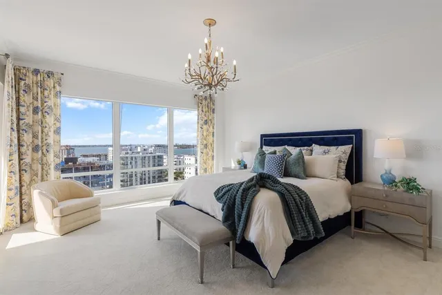 a living room with furniture city view and large windows