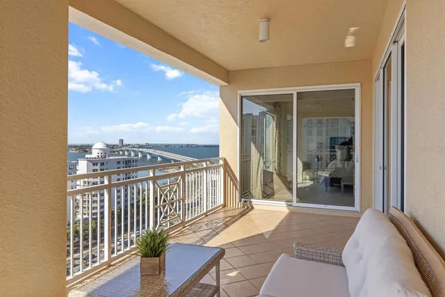 a living room with furniture potted plant and a large window