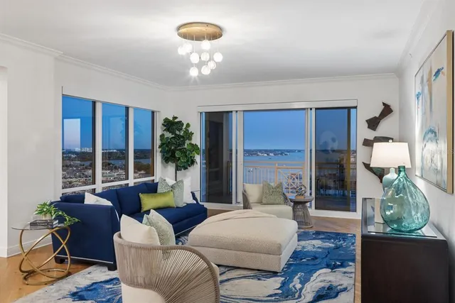 a living room with fireplace furniture and a chandelier