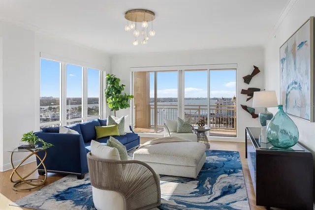 a living room with furniture and a chandelier