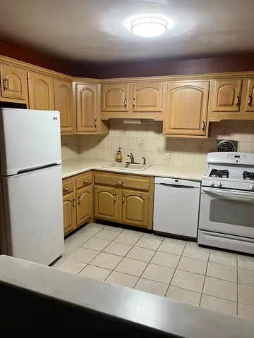 a kitchen with stainless steel appliances a stove sink and cabinets
