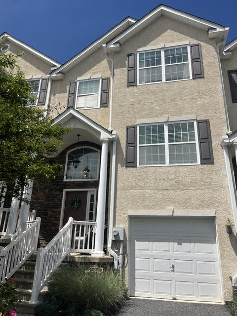 A well-maintained stucco facade with contrasting shutters welcomes you to this charming residence.
