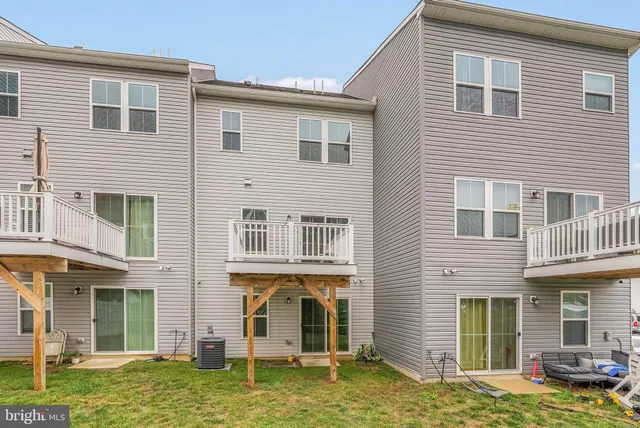 a backyard of a house with yard and outdoor seating