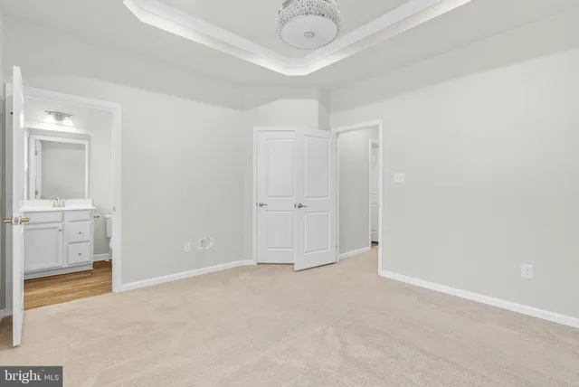 an empty room with cabinet and mirrors