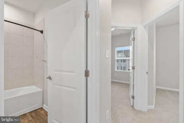 a bathroom with a shower and a glass door