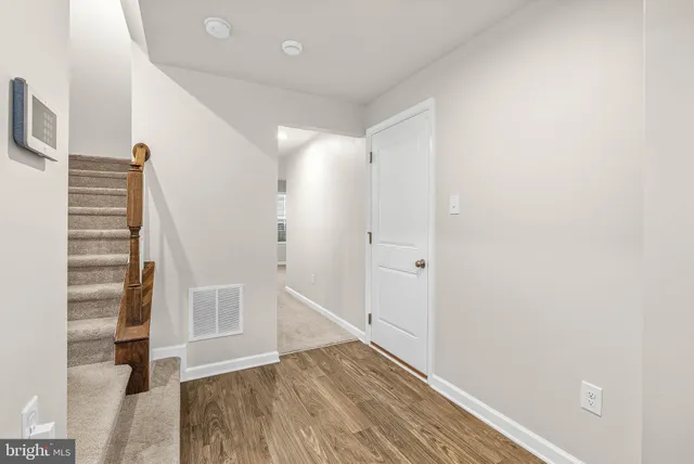 a view of wooden floor and windows in a room