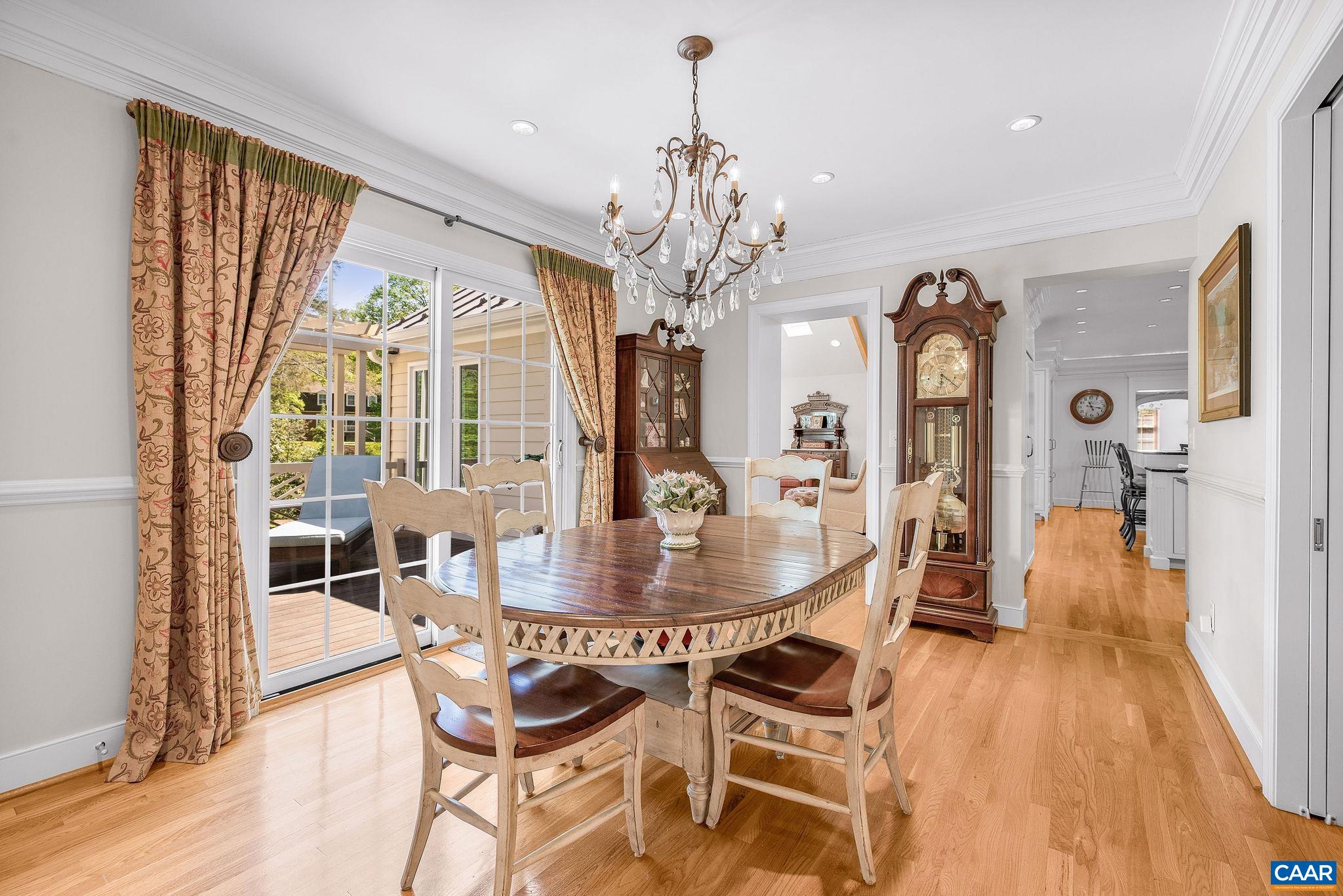 2001 Hessian Road Charlottesville, VA 22903 - Photo 12 of 47 a dining room with wooden floor a chandelier a wooden table and chairs