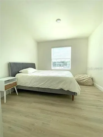 a bedroom with a bed and a table in it