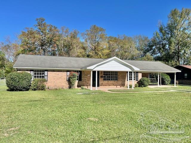 223 McRae Street Atmore, AL 36502 - Photo 1 of 23 a front view of a house with a yard