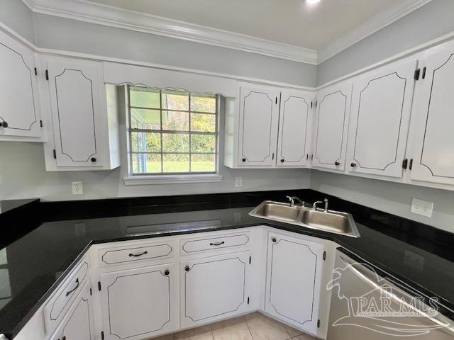 223 McRae Street Atmore, AL 36502 - Photo 12 of 23 a kitchen with white cabinets and a stove