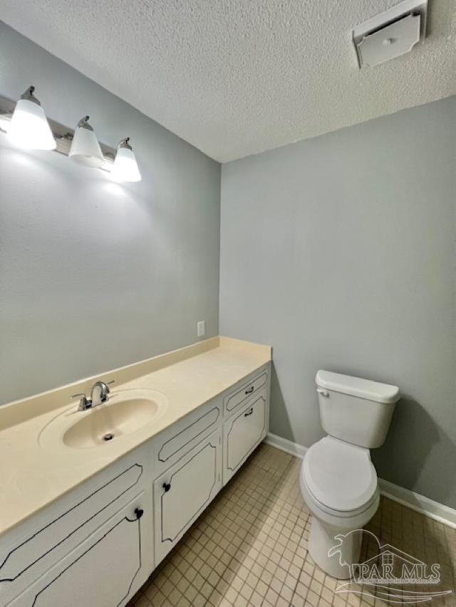 223 McRae Street Atmore, AL 36502 - Photo 17 of 23 a bathroom with a granite countertop toilet and a sink