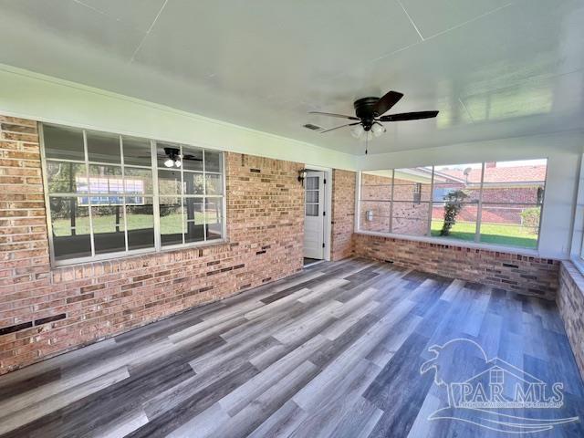 223 McRae Street Atmore, AL 36502 - Photo 19 of 23 a view of empty room with wooden floor and fan