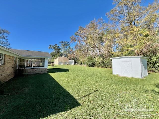 223 McRae Street Atmore, AL 36502 - Photo 21 of 23 a view of a house with backyard and a tree