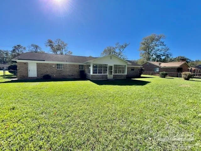 a front view of a house with a yard table and chairs
