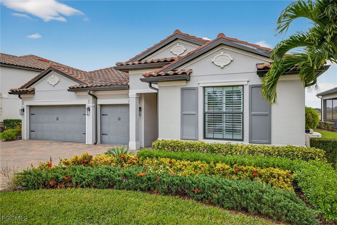 a front view of a house with a yard and garage