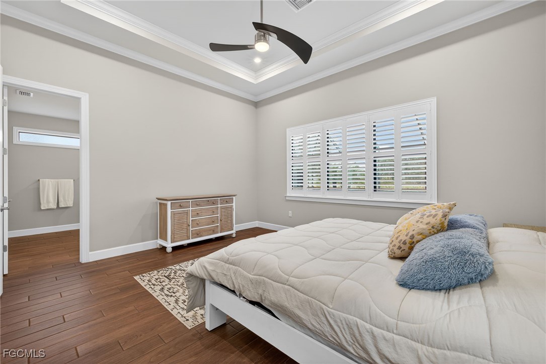 19815 Beverly Park Road Estero, FL 33928 - Photo 18 of 49 a bedroom with a bed and wooden floor