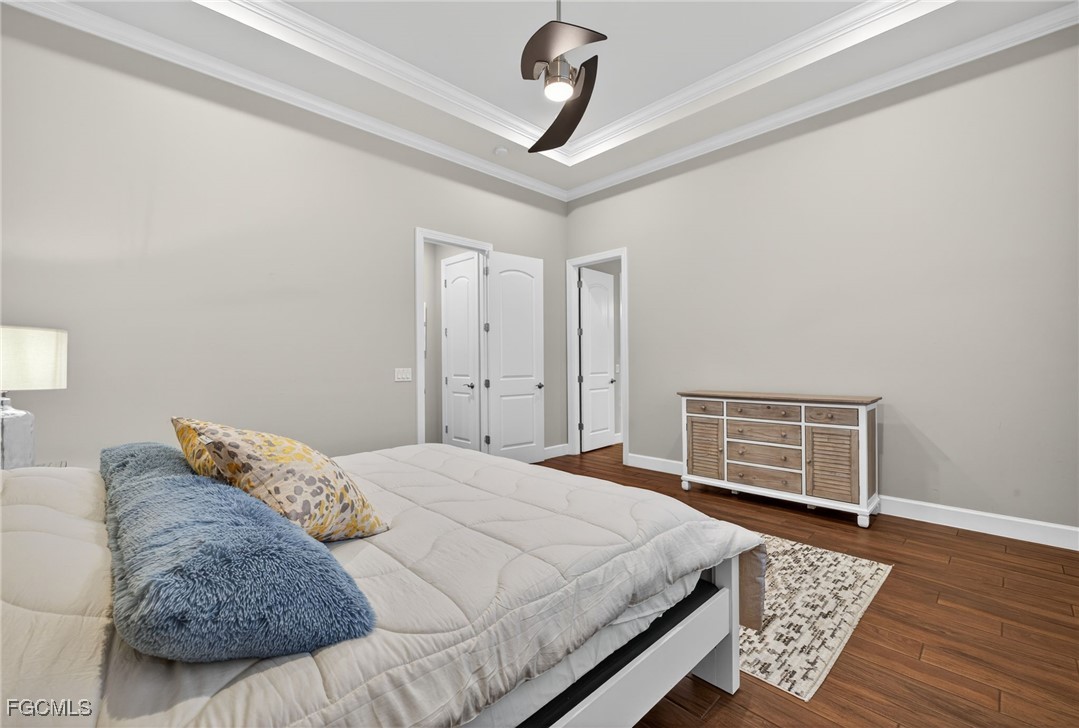 19815 Beverly Park Road Estero, FL 33928 - Photo 19 of 49 a bedroom with a bed a dresser and wooden floor