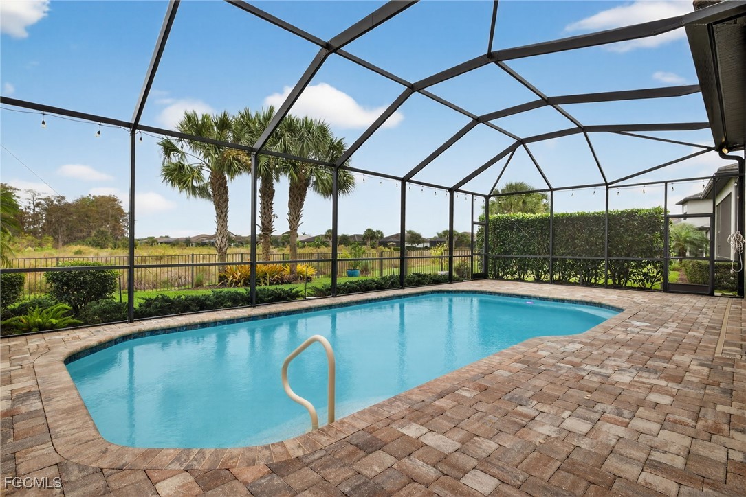 19815 Beverly Park Road Estero, FL 33928 - Photo 2 of 49 a view of a swimming pool with a porch