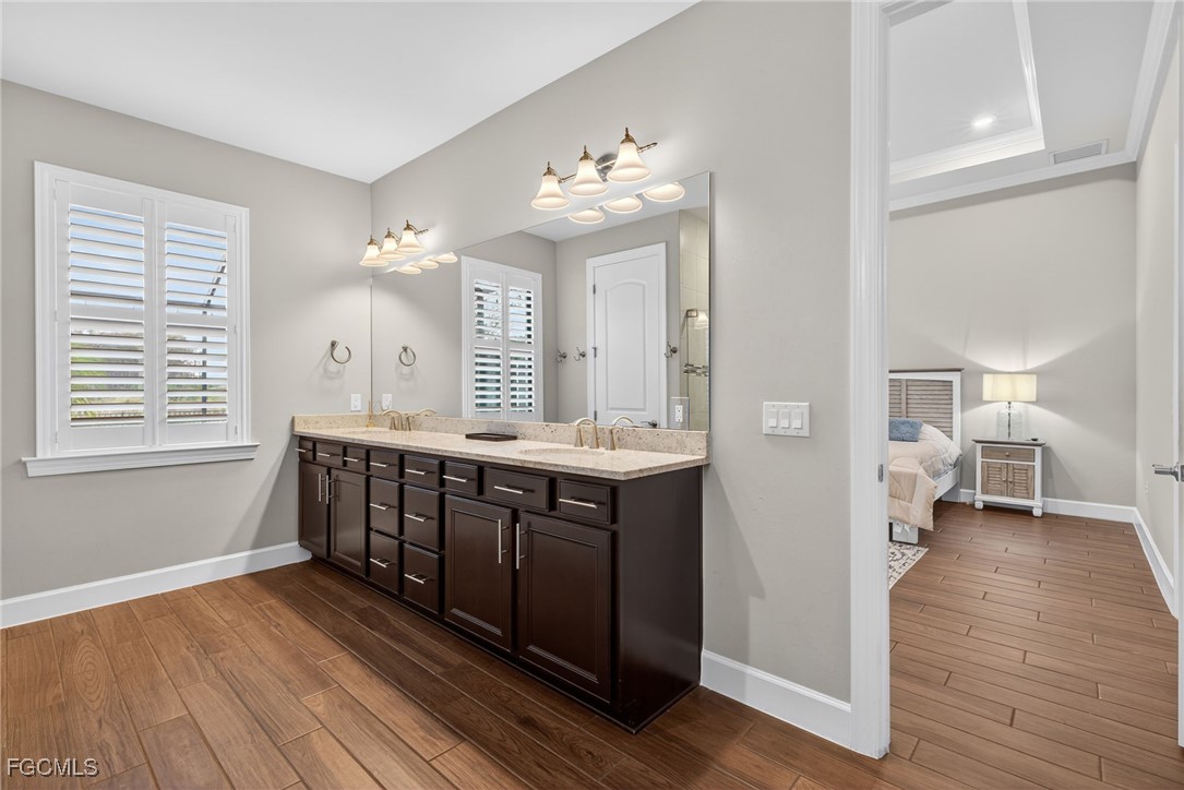 19815 Beverly Park Road Estero, FL 33928 - Photo 21 of 49 a large spacious bathroom with a large mirror a sink a vanity and a window