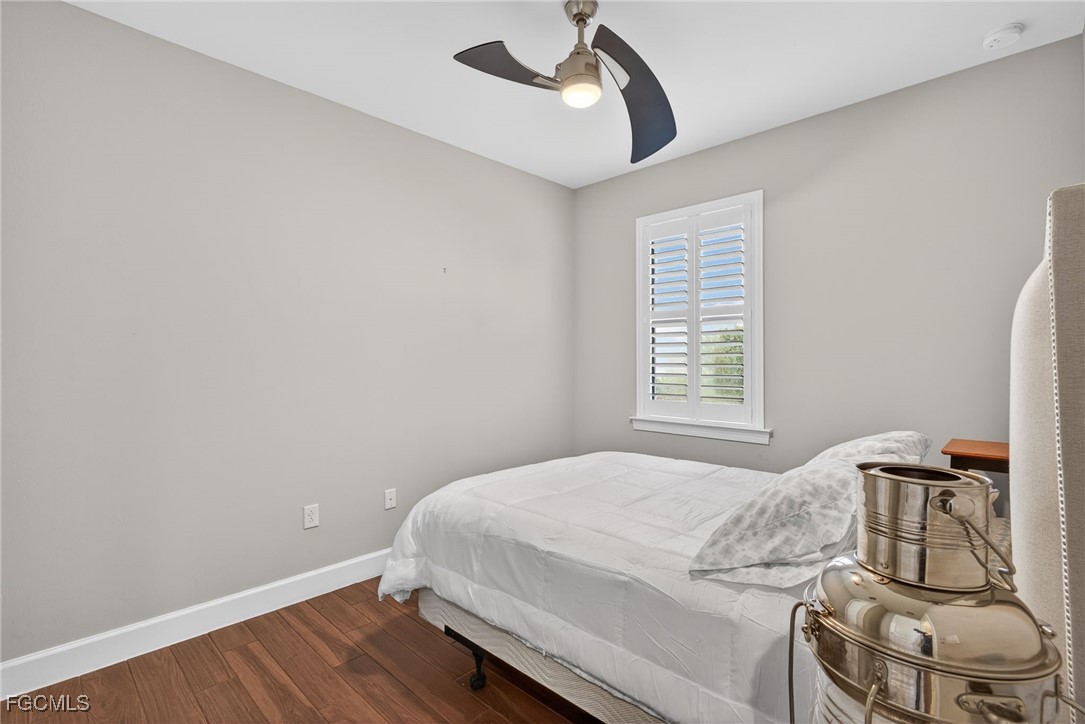 19815 Beverly Park Road Estero, FL 33928 - Photo 22 of 49 a bedroom with a bed and wooden floor