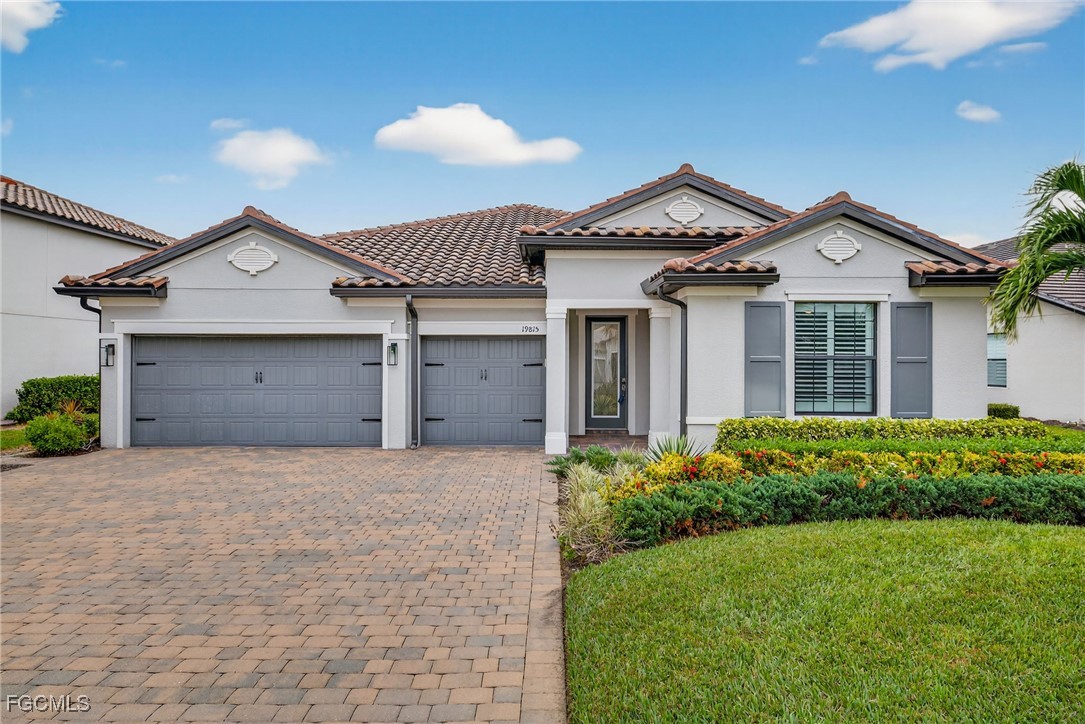 19815 Beverly Park Road Estero, FL 33928 - Photo 30 of 49 a front view of a house with a yard and garage
