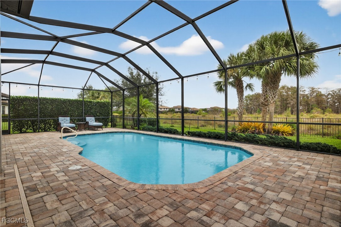 19815 Beverly Park Road Estero, FL 33928 - Photo 31 of 49 a view of a swimming pool with a porch