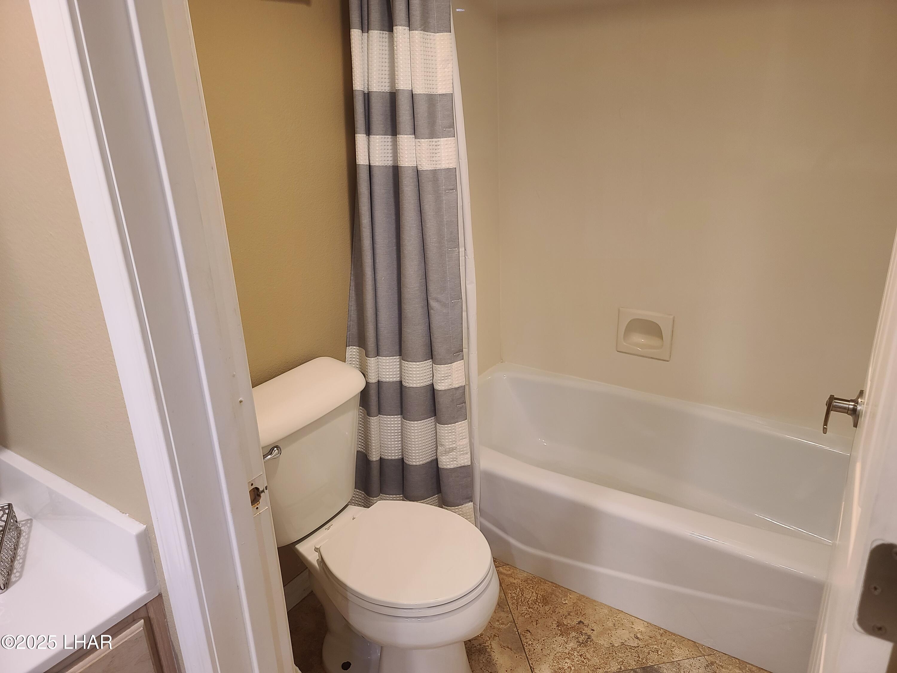 94 London Bridge Road, Unit 108 Lake Havasu City, AZ 86403 - Photo 28 of 38 a white toilet sitting next to a bath tub