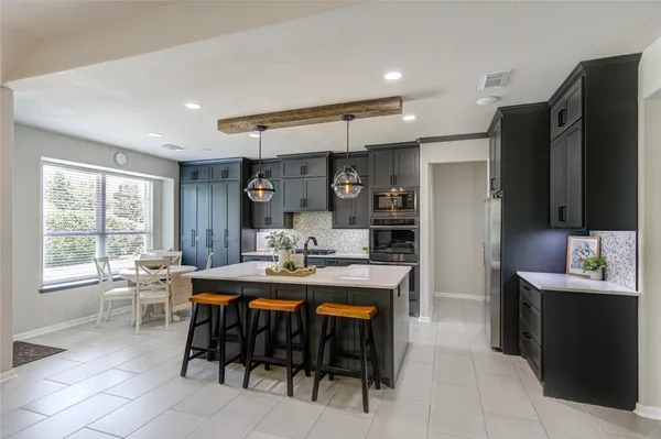 a view of a workspace with furniture and wooden floor