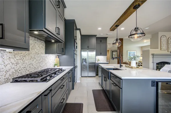 a spacious bedroom with a bed and a chandelier