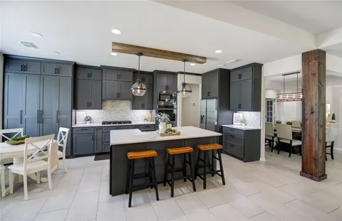 a spacious bedroom with a bed and a chandelier