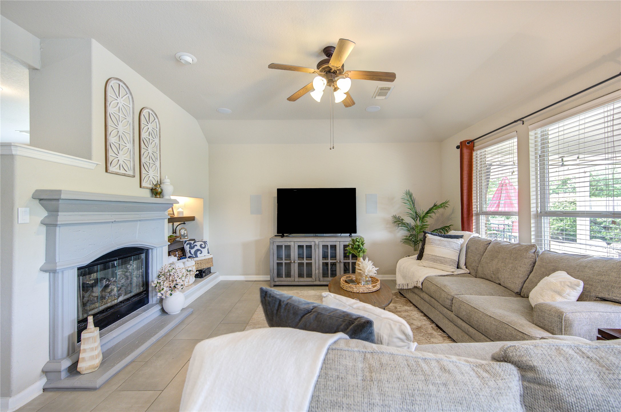 20026 Mellishaw Court Spring, TX 77379 - Photo 20 of 49 a living room with furniture a fireplace and a flat screen tv