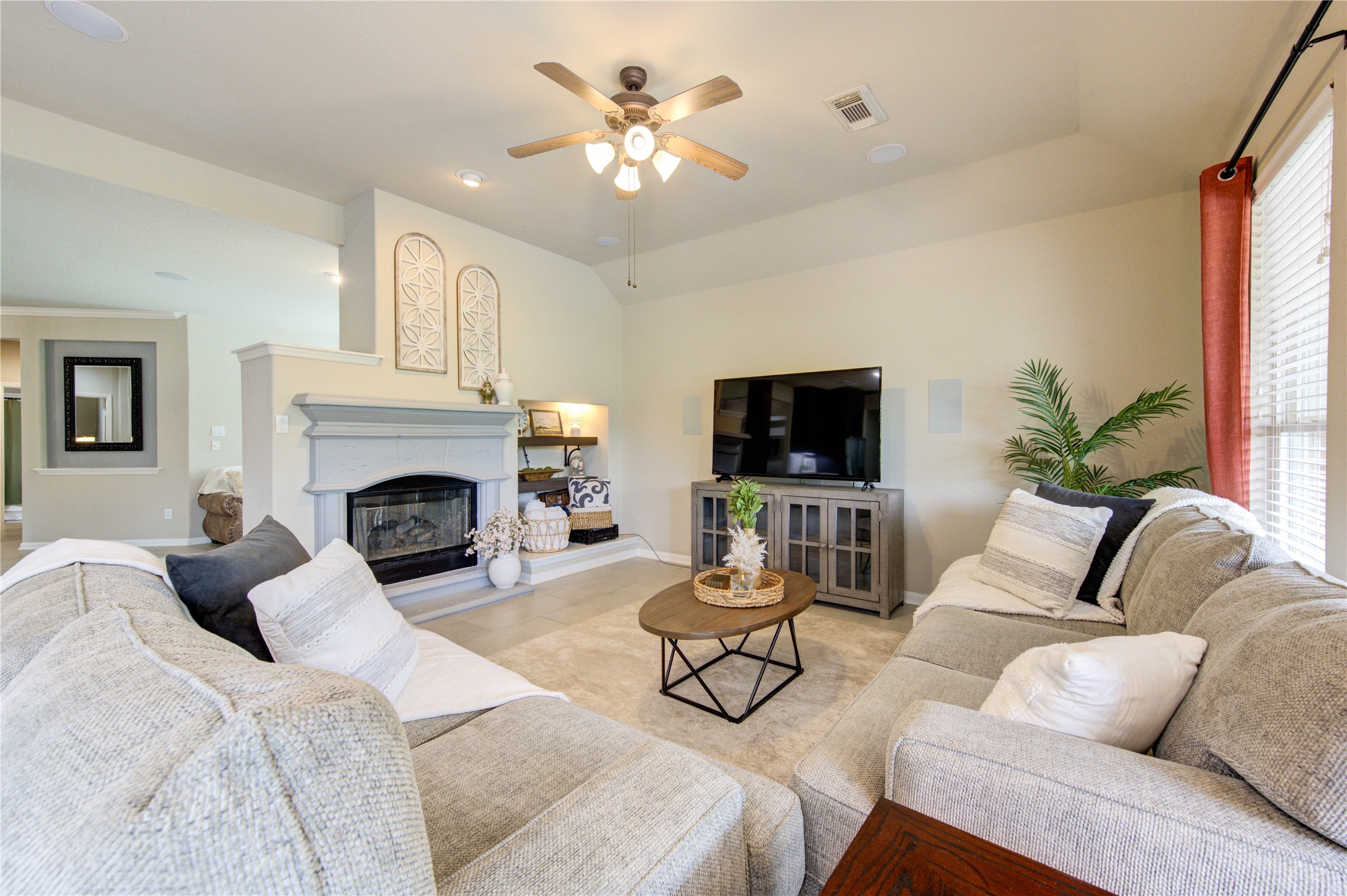 20026 Mellishaw Court Spring, TX 77379 - Photo 21 of 49 a living room with furniture a fireplace and a flat screen tv