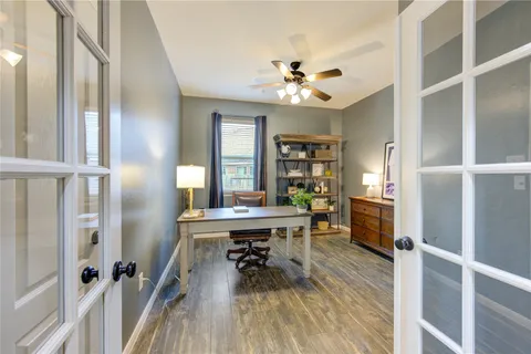a living room with patio furniture and a floor to ceiling window