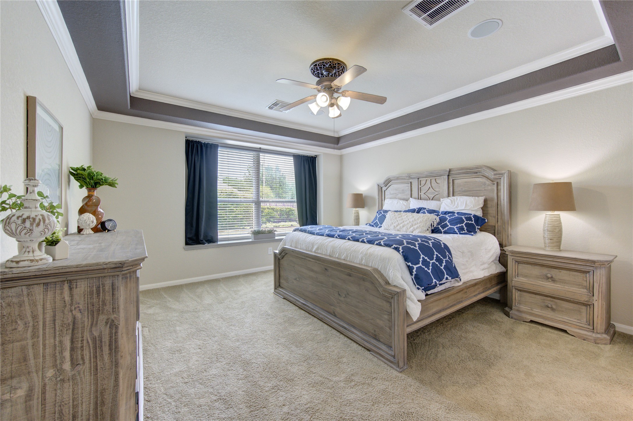 20026 Mellishaw Court Spring, TX 77379 - Photo 26 of 49 a bedroom with a large bed and a chandelier