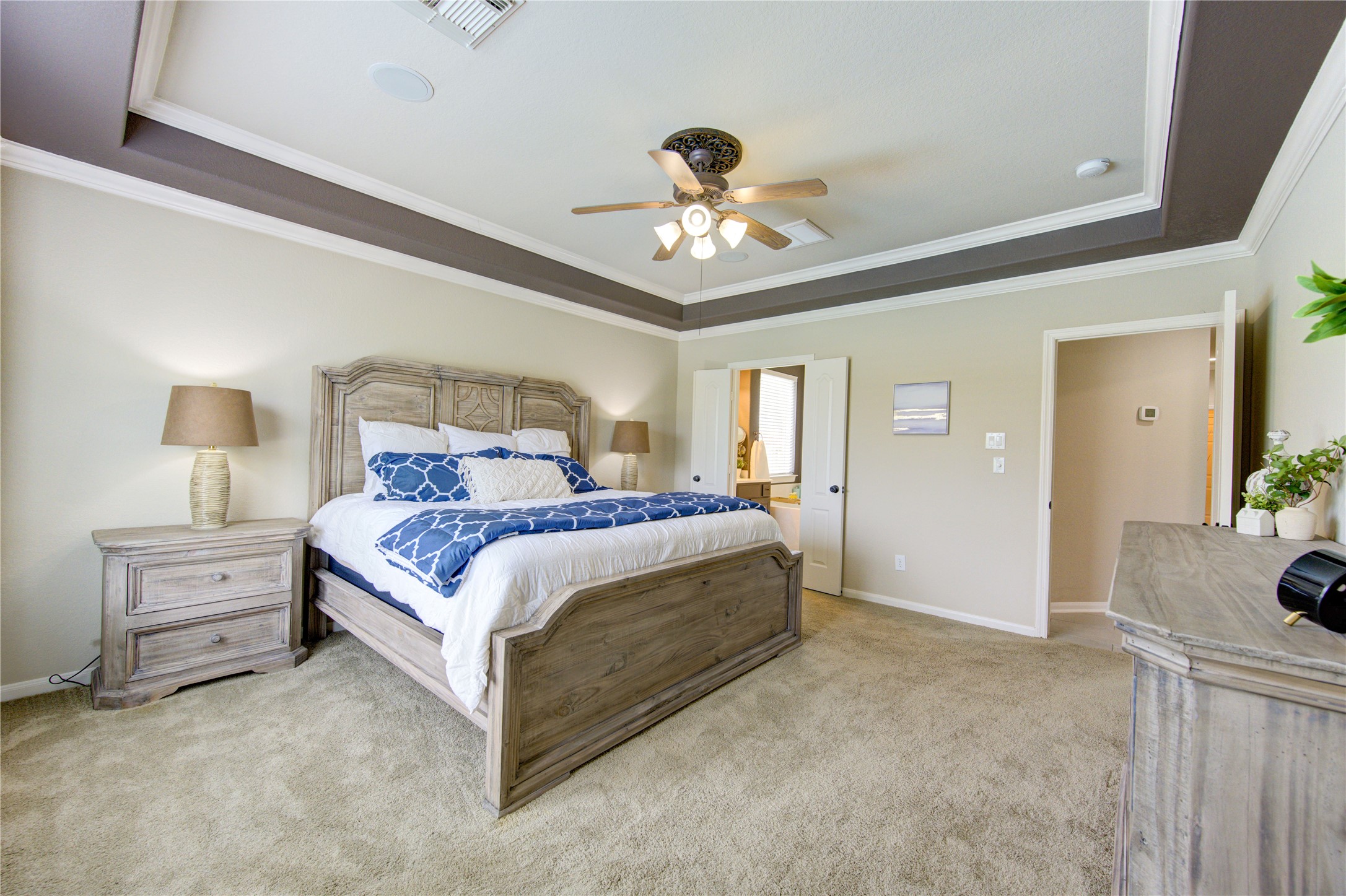 20026 Mellishaw Court Spring, TX 77379 - Photo 27 of 49 a spacious bedroom with a bed and a chandelier
