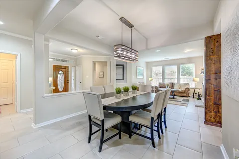 a living room with furniture a rug a fireplace and a large window