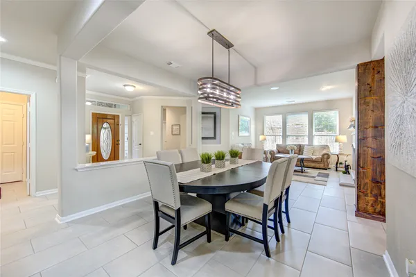 a kitchen with a table chairs sink and cabinets
