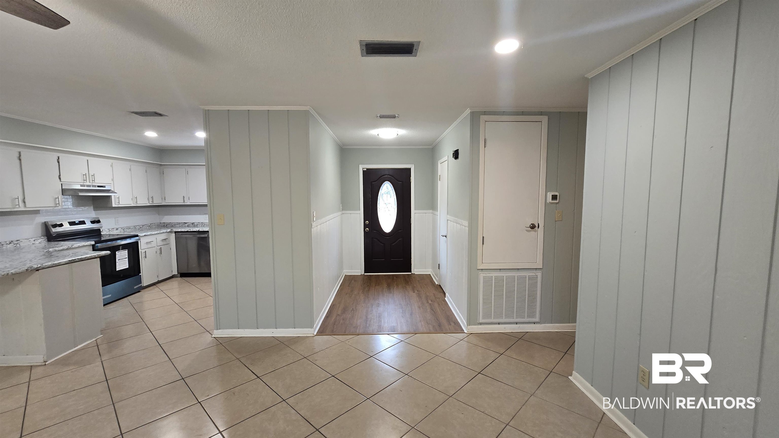 615 East Pedigo Avenue Foley, AL 36535 - Photo 11 of 31 Foyer featuring wood walls, crown molding, a wainscoted wall, recessed lighting, and light tile patterned floors