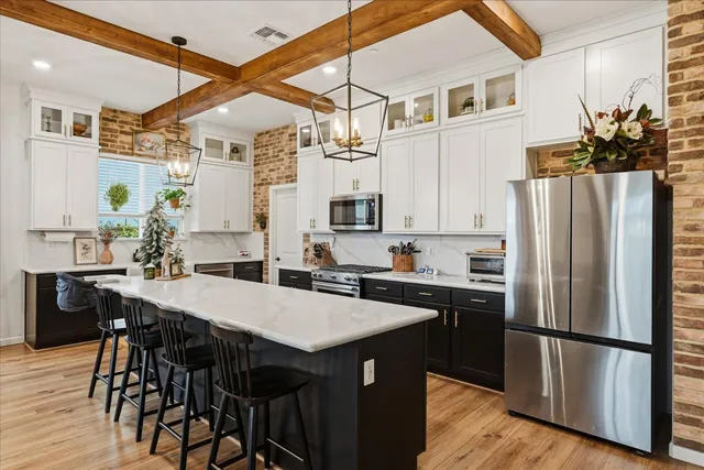 a view of a kitchen area with furniture and wooden floor