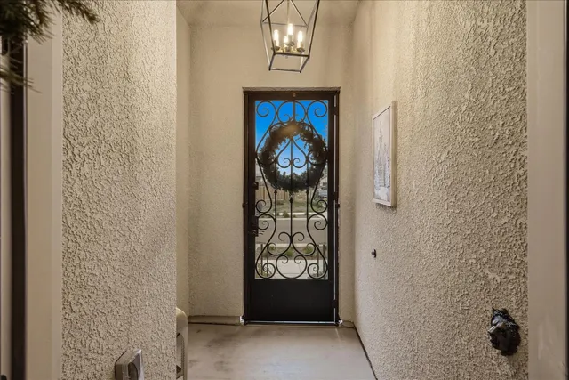 a view of a hallway with wooden floor and stairs