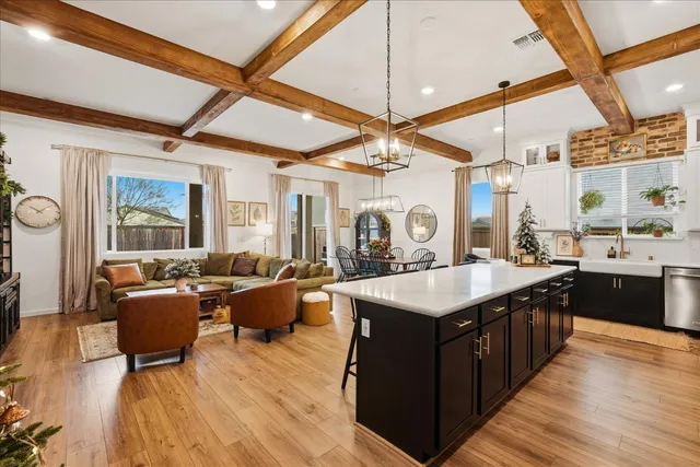 a living room with furniture a rug and a window