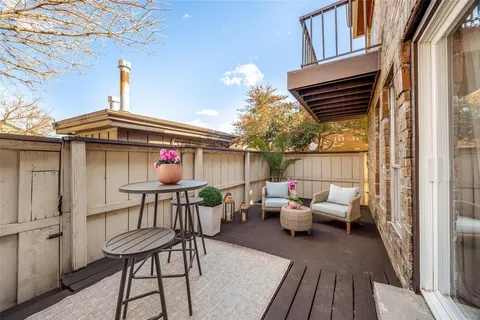 a view of a chairs and table in the balcony