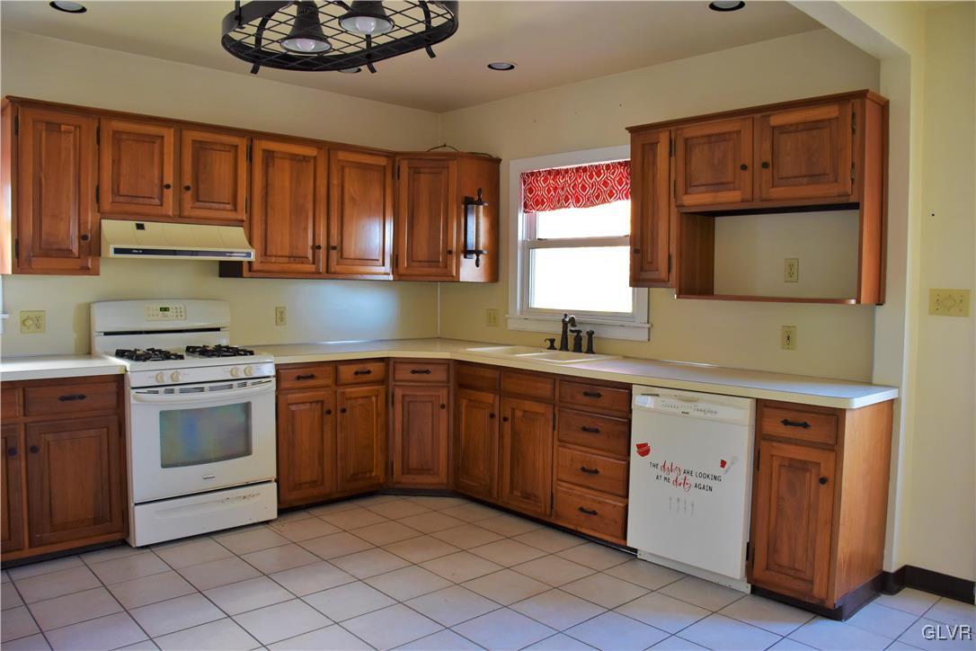 1017 Howertown Road Catasauqua, PA 18032 - Photo 4 of 15 a kitchen with stainless steel appliances granite countertop a sink and cabinets