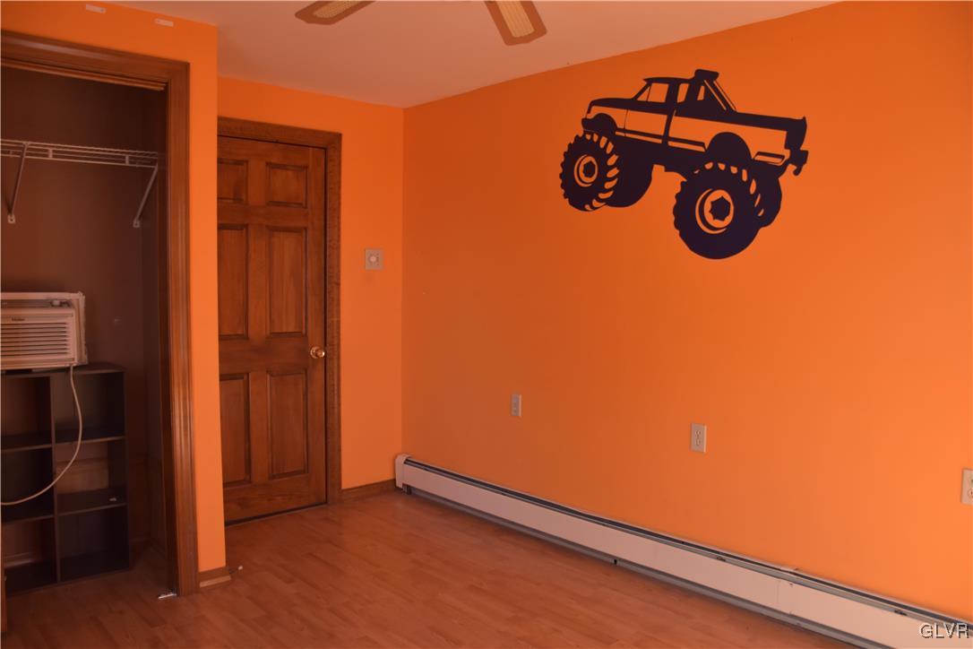 1017 Howertown Road Catasauqua, PA 18032 - Photo 10 of 15 an empty room with wooden floor and mirror