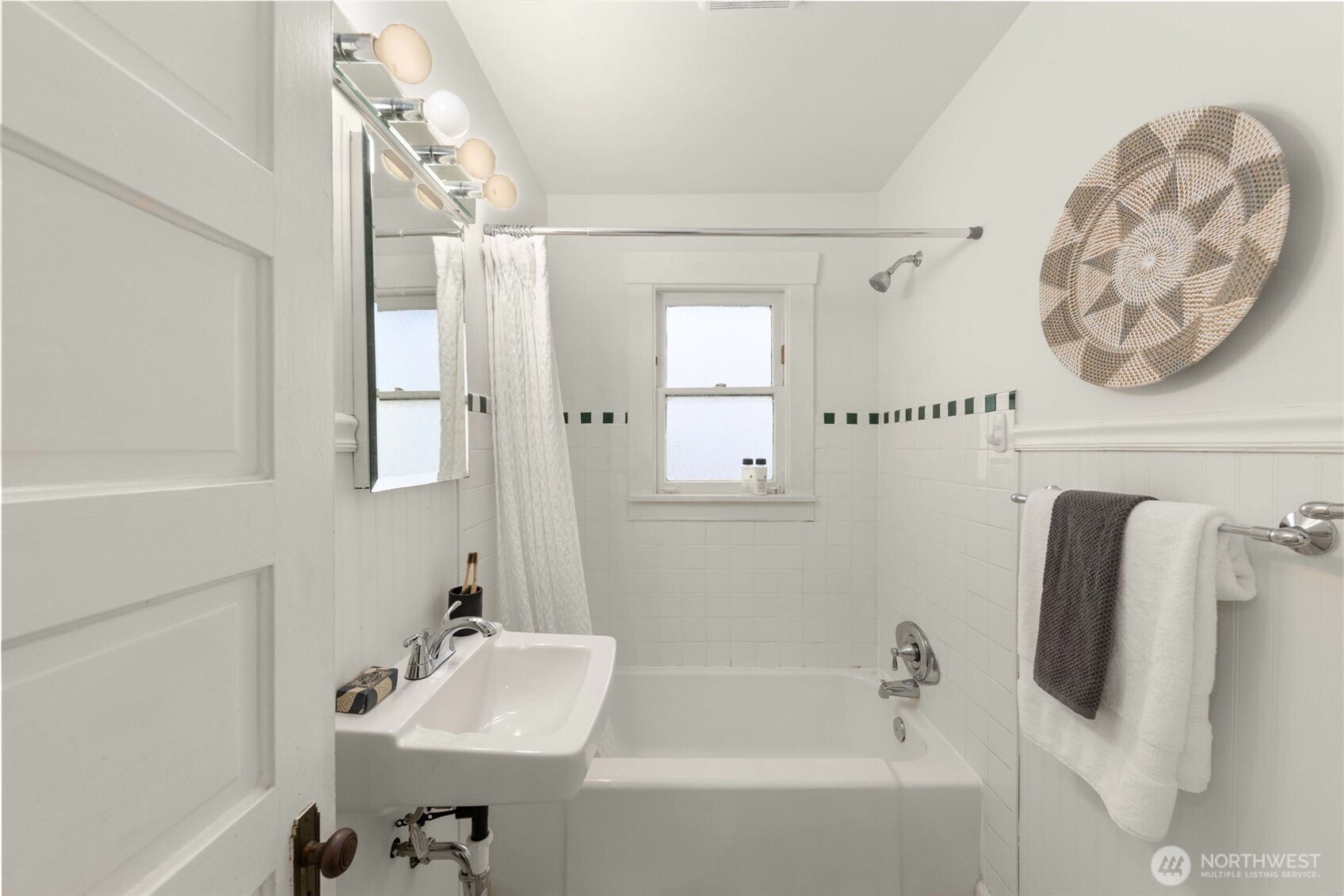 619 Northwest 89th Street Seattle, WA 98117 - Photo 14 of 24 a bathroom with a sink and mirror with bathtub