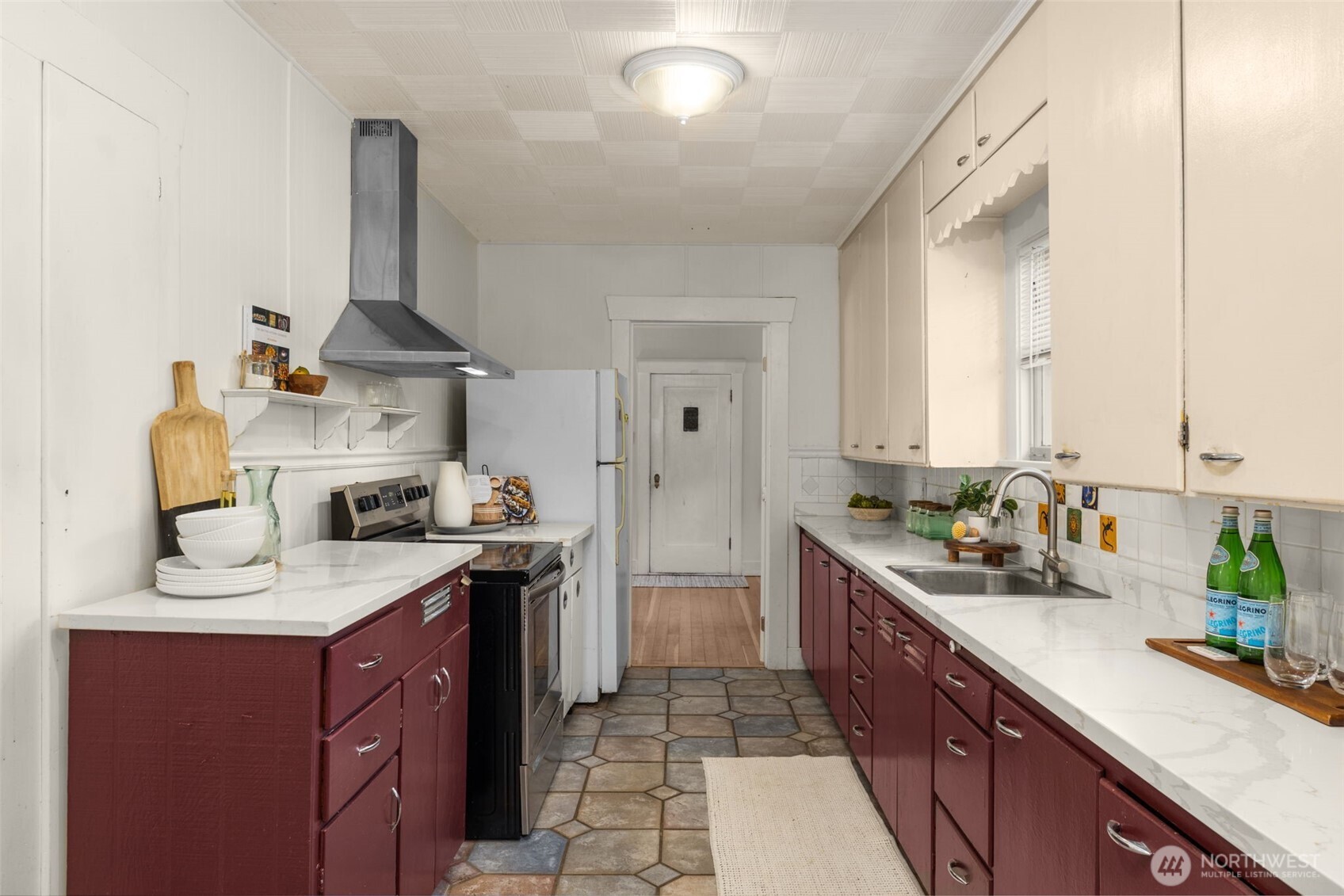 619 Northwest 89th Street Seattle, WA 98117 - Photo 9 of 24 a kitchen with a sink stove and cabinets
